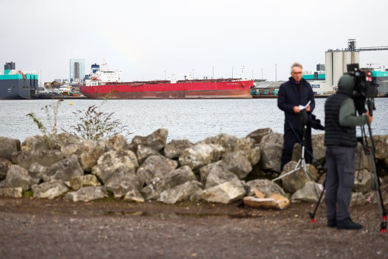 A news crew stand across the water from the Liberia-flagged oil tanker Nave Andromeda at Southampton Docks, following a security incident aboard the ship the night before off the coast of Isle of Wight, in Southampton