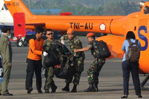 Soldiers carry a body bag containing the remains of passengers of the ill-fated Sukhoi plane crash, on arrival at Halim Perdanakusuma airport in Jakarta, on May 11. Rescuers said the bodies of those who perished when Sukhoi's new Superjet 100 hit Mount Salak in western Java on Wednesday, killing all on board, were badly dismembered