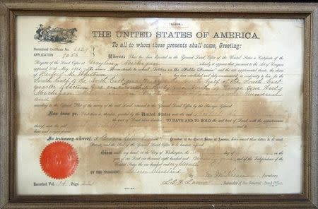 The original Homestead property deed to Michigan farm land, dated February 10, 1894, hangs in the farm house owned by Mildred Lutz, 93, in Alanson, Michigan December 26, 2011. REUTERS/Rebecca Cook