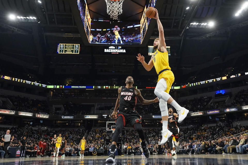 Indiana Pacers forward Domantas Sabonis (11) shoots in front of Miami Heat forward Udonis Haslem (40) during the first half of an NBA basketball game in Indianapolis, Friday, Dec. 3, 2021. (AP Photo/AJ Mast)