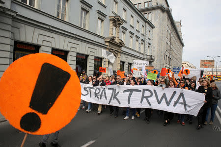 People hold banners during a rally to support a nationwide teachers' strike in central Warsaw, Poland April 24, 2019. Banner reads "The Strike Continues" Agencja Gazeta/Jedrzej Nowicki via REUTERS