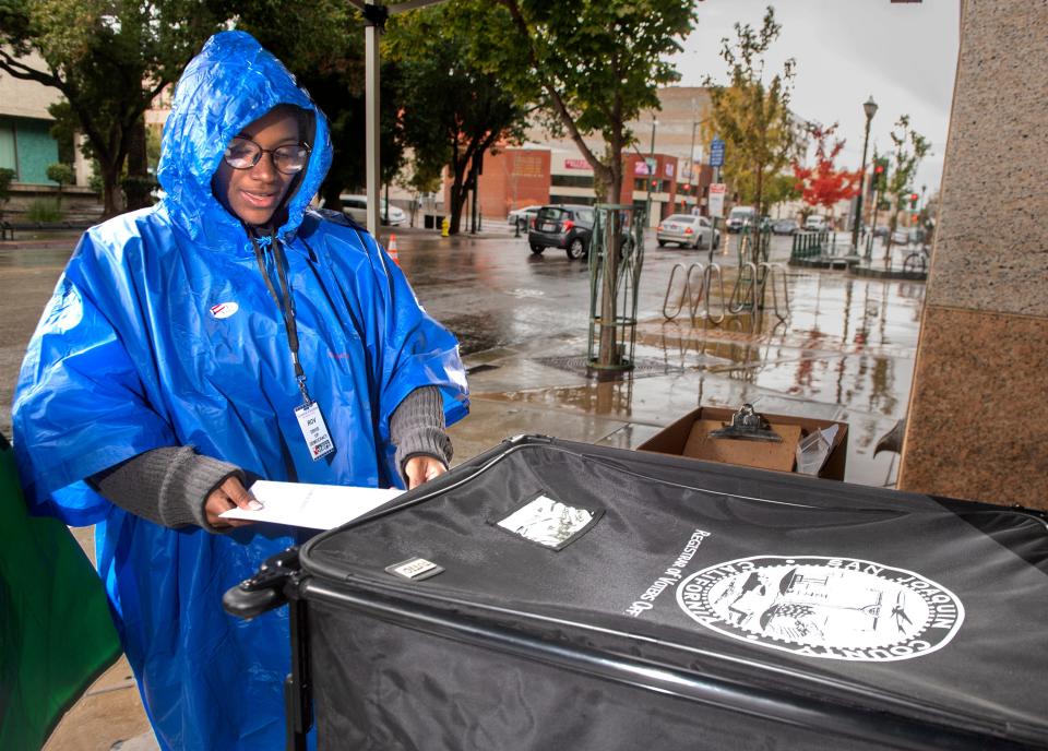 Election worker Jayla Thompson puts a completed ballot into a ballot box at the ballot drop-off point at the San Joaquin County Administration Building in downtown Stockton on Tuesday, Nov. 8, 2022. 