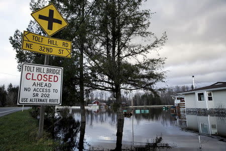 Flood waters of the Snoqualmie River surround a residence off State Route 203 during a storm in Carnation, Washington December 9, 2015. REUTERS/Jason Redmond