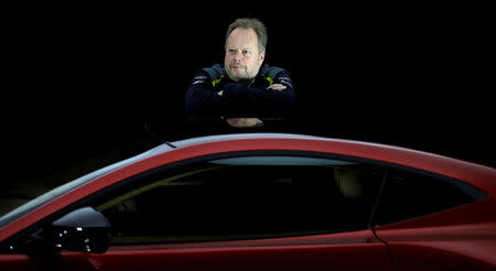 Andy Palmer, CEO of Aston Martin, poses for a photograph next to the company's new Vantage car in Gaydon, Britain November 20, 2017. REUTERS/Phil Noble