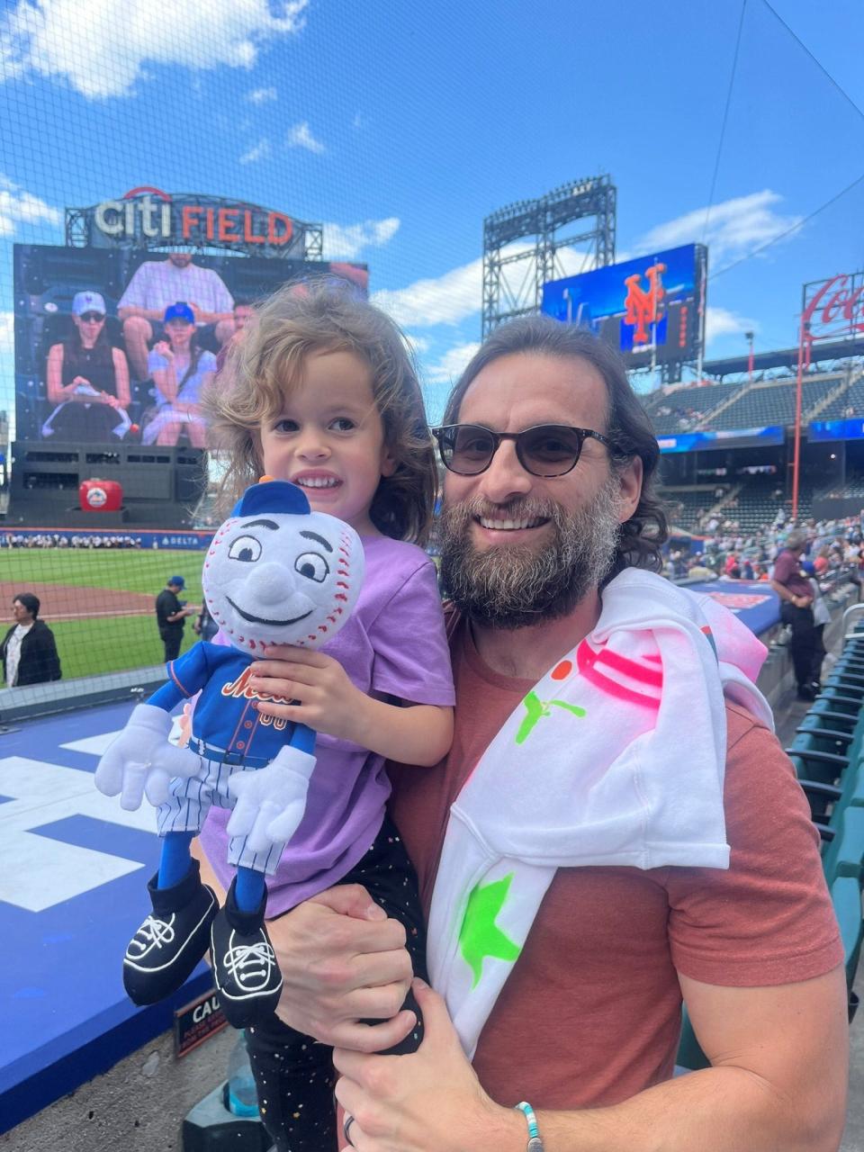 Yoni Garber, 39, a longtime Mets fan with his daughter and her Mr. Met toy