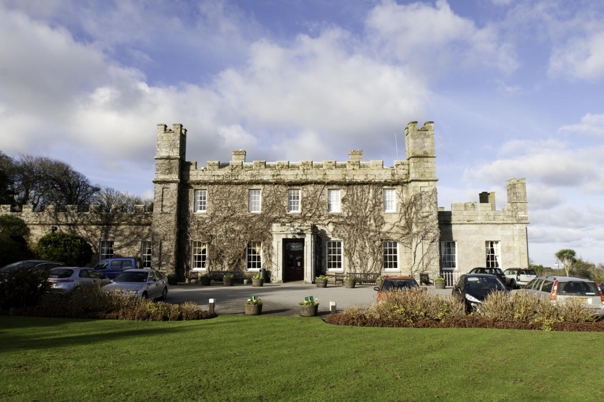 St Ives, United Kingdom - January 28, 2012: Tregenna Castle was built in 1774 by Samuel Stephens as a stately home. The castle is now a popular hotel and wedding venue. The image shows the front and entrance to the castle and the foreground green. Taken on a winters morning.