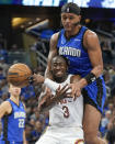 Orlando Magic forward Paolo Banchero, top, fouls Cleveland Cavaliers guard Caris LeVert (3) on a shot attempt during the first half of Game 3 of an NBA basketball first-round playoff series Thursday, April 25, 2024, in Orlando, Fla. (AP Photo/John Raoux)