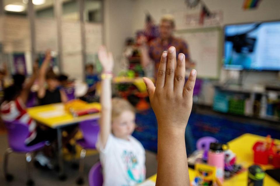 Third graders raise their hands to answer questions during a lesson on May 20, 2022 at Buckhorn Creek Elementary in Holly Springs, N.C. Chronic student absenteeism rose to 31% in North Carolina schools in the 2021-22 school year. Scott Sharpe/ssharpe@newsobserver.com