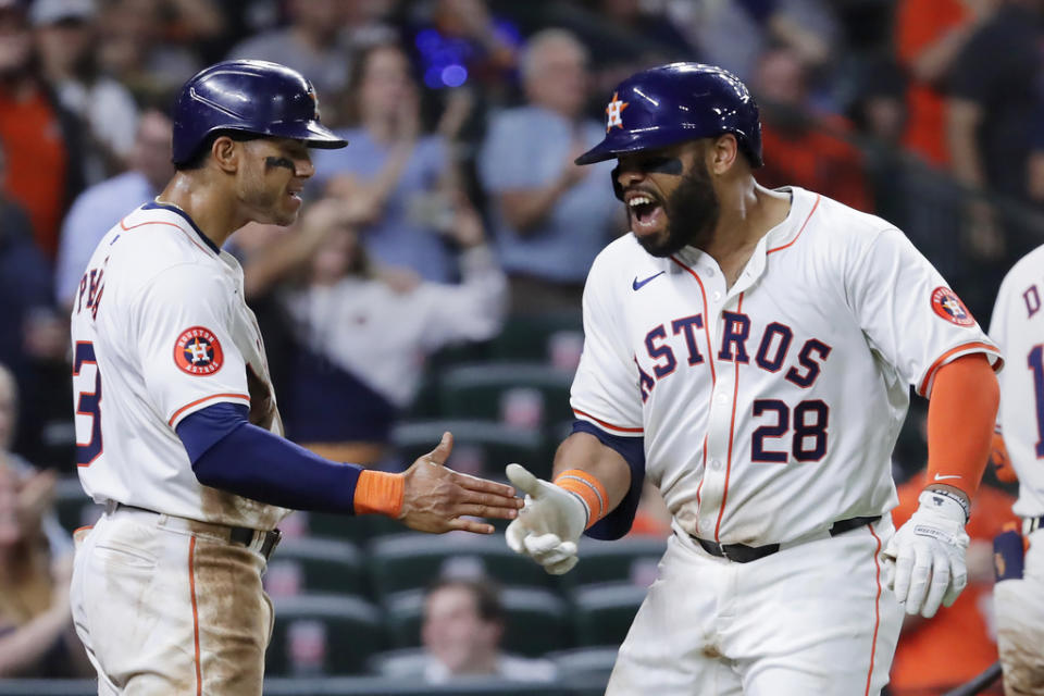 Houston Astros’ <a class="link " href="https://sports.yahoo.com/mlb/players/11768/" data-i13n="sec:content-canvas;subsec:anchor_text;elm:context_link" data-ylk="slk:Jeremy Pena;sec:content-canvas;subsec:anchor_text;elm:context_link;itc:0">Jeremy Pena</a>, left, and Jon Singleton (28) celebrate after they scored on a two-run home run by Singleton against the Cleveland Guardians during the sixth inning of a baseball game Thursday, May 2, 2024, in Houston. (AP Photo/Michael Wyke)