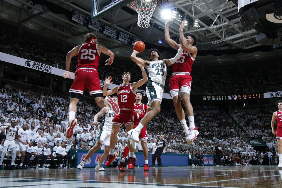 Michigan State's Malik Hall (25) goes to the basket gainst Indiana's Race Thompson, left, MIller Kopp (12) and Trayce Jackson-Davis, right, during the second half of an NCAA college basketball game Tuesday, Feb. 21, 2023, in East Lansing, Mich. (AP Photo/Al Goldis)