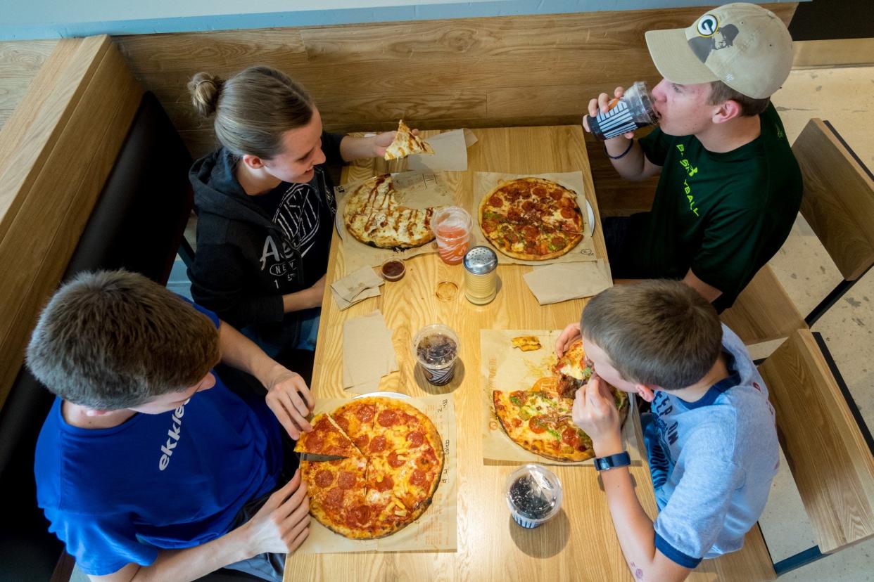 Customers enjoy individual, customized pies at Blaze Pizza in Jupiter in this 2019 photo.   