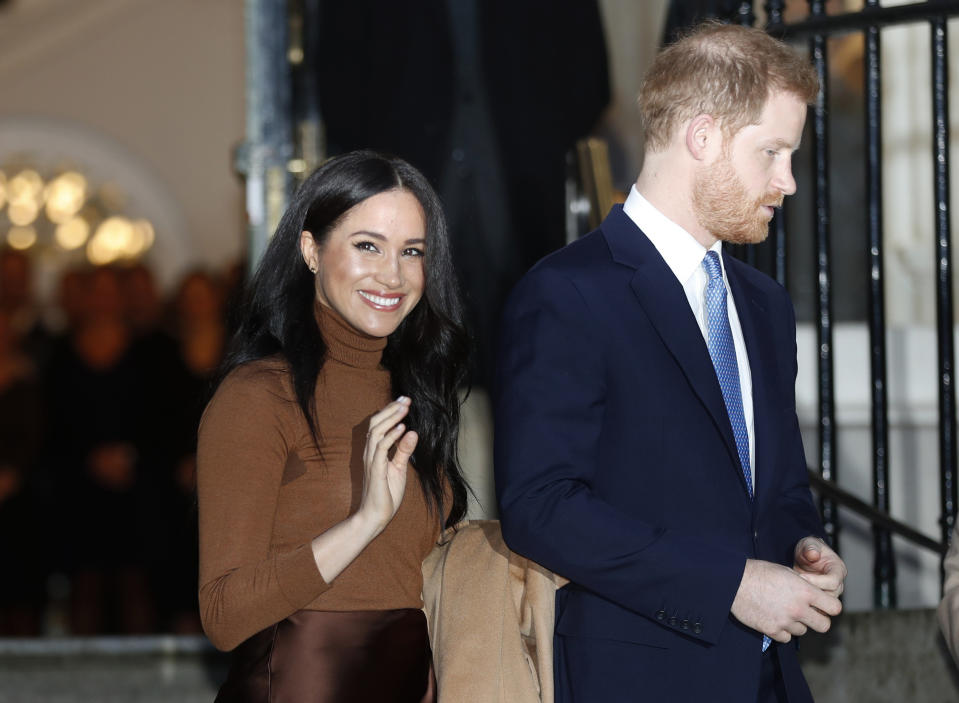 FILE - In this Jan. 7, 2020, file photo, Britain&#39;s Prince Harry and Meghan, Duchess of Sussex leave after visiting Canada House in London, after their recent stay in Canada. As Prince Harry and Meghan step back as senior royals, questions linger over the role race has played in her treatment in Britain. (AP Photo/Frank Augstein, File)