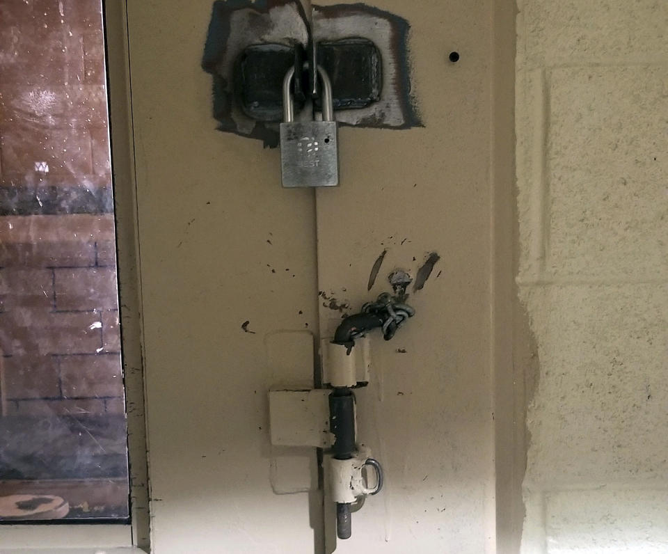FILE - This undated photo provided by the Arizona Department of Corrections shows a cell door in Arizona State Prison Complex-Lewis prison in Buckeye, Ariz., with an added pin and padlock to keep inmates from opening it when locked. A new report says locks failed for years at an Arizona prison and allowed for serious beatings of prisoners and guards, but Department of Corrections Director Charles Ryan failed to appreciate the seriousness of the problem until video of an assault was broadcast on television. (Arizona Department of Corrections via AP, File)