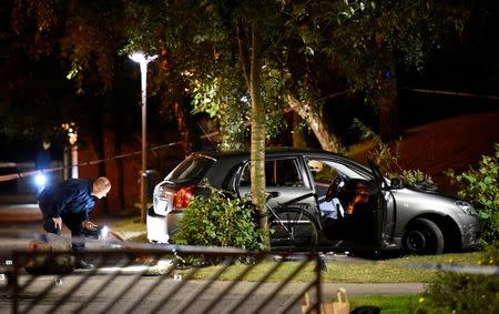 FILE PHOTO: Police technicians examine the car which people who were injured were traveling in, after a shooting in southern Malmo, Sweden September 25, 2016. TT News Agency/Emil Langvad via Reuters/File Photo