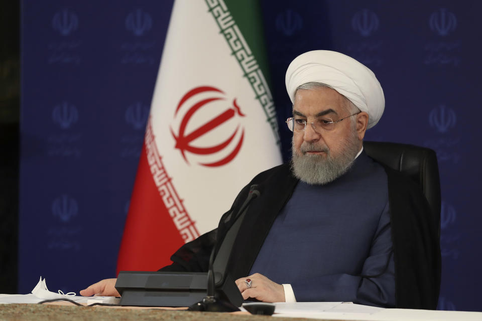 In this photo released by the official website of the office of the Iranian Presidency, President Hassan Rouhani attends a meeting of the national headquarters of the fight against the COVID-19, in Tehran, Iran, Saturday, July 18, 2020. He estimated as many as 25 million Iranians could have been infected with the coronavirus since the outbreak's beginning, citing an Iranian Health Ministry study that has so far not been made public, the state-run IRNA news agency reported. Writing in Farsi at top right reads, "The Presidency." (Iranian Presidency Office via AP)