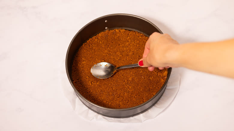 base being pushed down with spoon 