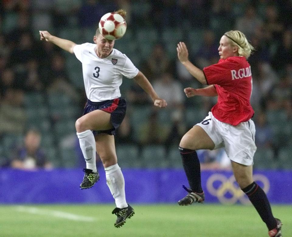 FILE - In this Sept. 28, 2000, file photo, United States' Christie Pearce, left, heads the ball as Norway's Ragnhild Gulbrandsen defends during the women's soccer final at the Summer Olympics in Sydney. American national team defenders Steve Cherundolo and Pearce have been elected to the U.S. National Soccer Hall of Fame. (AP Photo/Ricardo Mazalan, File)