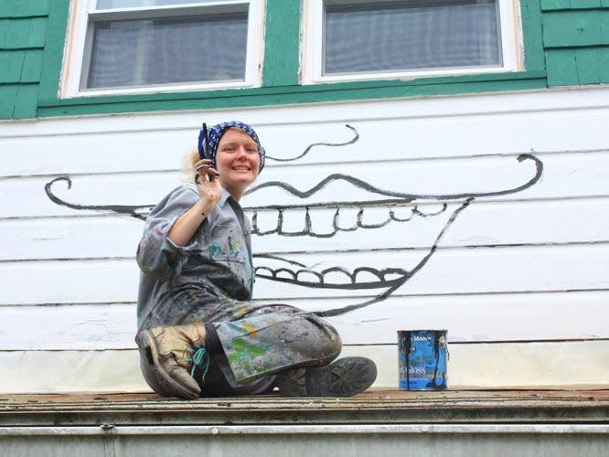 O'Sullivan painting the exterior of her home.