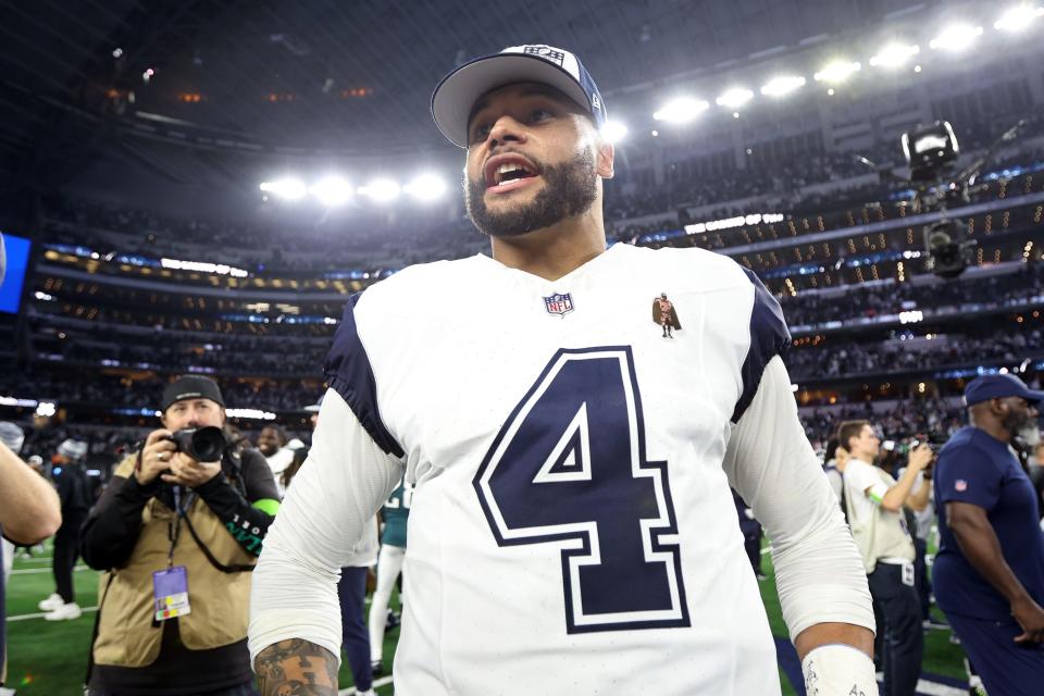 Dak Prescott smiles on the field after Sunday night's win over the Eagles at AT&T Stadium.