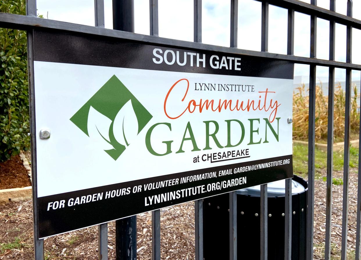 Lynn Institute Community Garden signage is posted on a gate at the Lynn Institute Community Garden at Chesapeake, NW 62 and N Shartel Ave.