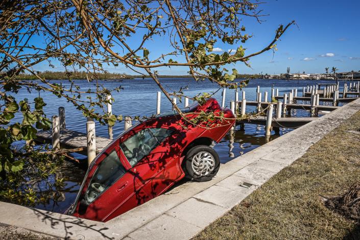 The storm surge carried this car out of a driveway and off a dock.
