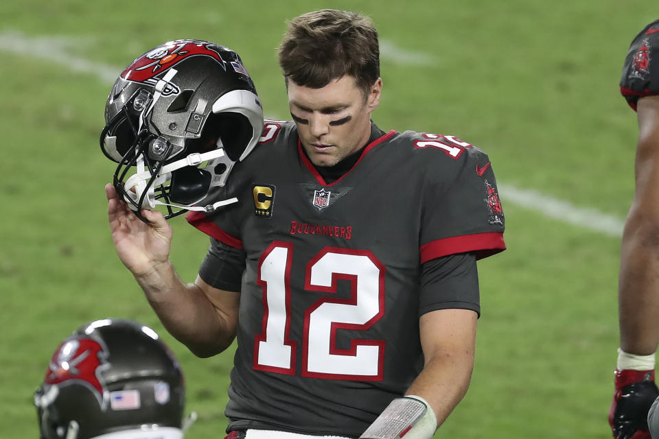 Tampa Bay Buccaneers quarterback Tom Brady (12) reacts as he leaves the field after throwing an intrception to Los Angeles Rams strong safety Jordan Fuller during the second half of an NFL football game Monday, Nov. 23, 2020, in Tampa, Fla. (AP Photo/Mark LoMoglio)