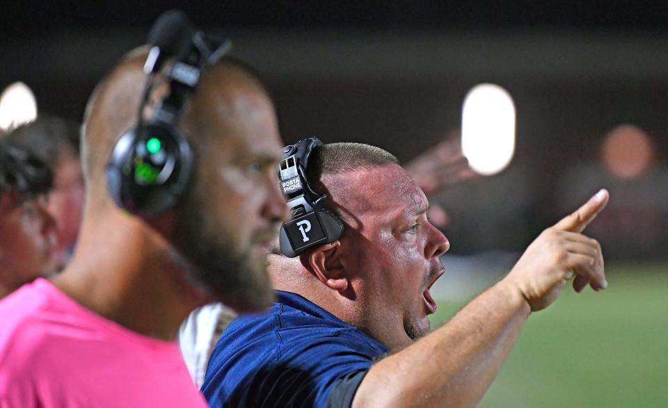 Parrish's Assistant Head Coach, Frank Post barking orders from the sidelines. Parrish Community High School Bulls win 35 to 28 over Braden River High Pirates during a district home game at the Bulls stadium Friday night, Oct. 13, 2023, in Parrish.