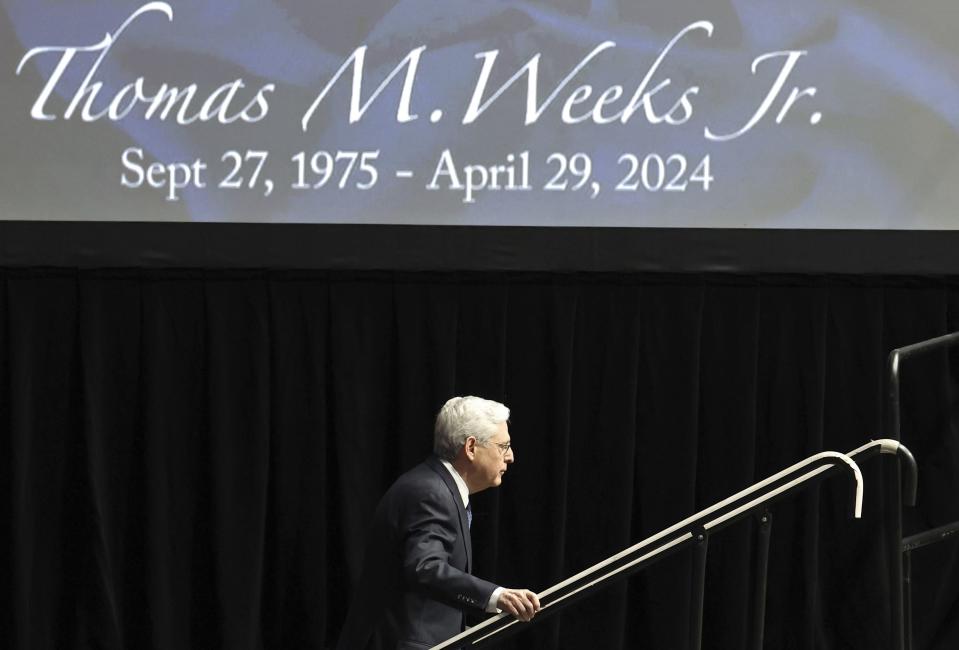 Attorney General Merrick Garland climbs the stairs to the lectern to speak during a memorial service for slain U.S. Marshal Thomas Weeks Jr., at Bojangles Coliseum in Charlotte, N.C. on Monday, May 6, 2024. Weeks Jr. died during a standoff with a gunman on Monday, April 29. (Jeff Siner/The Charlotte Observer via AP)