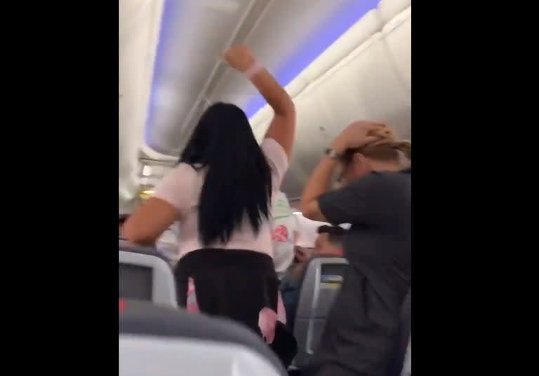 A couple was removed from an American Airlines flight after the woman chased her boyfriend down the aisle and smashed a laptop computer over his head for “looking at another woman”.Shocking footage of the incident, which took place onboard a flight from Miami to Los Angeles, was shared on social media.In it, the female passenger can be heard loudly swearing at her other half.“You want to try to look at other women? F*** you,” she says.A flight attendant can be seen trying to calm the woman down, appealing to her by pointing out that a small child is sitting behind them.WARNING: The video below contains swearing.> hot girl summer has been postponed until further notice pic.twitter.com/FpxR61NA7G> > — Julia Scorupco (@juliascorupco) > > July 22, 2019“Yeah I know, I f***ing consoled the f***ing child,” the woman responds loudly.She also tells her boyfriend repeatedly to shut up.Another passenger can be heard saying, “Why don’t they take her off the plane?”After the man follows cabin crew instructions to accompany them to the front of the aircraft, his girlfriend chases him down the aisle and hits him with a laptop and her fists, causing other passengers to cry out in fear.The woman then barges past several flight attendants to retrieve her bag.“Ma’am, you’re going to be charged with assault,” one tells her, to which she responds: “Yeah, whatever.”The video was shared on Twitter by fellow passenger Julia Scorupco. “Yes she hulk smashed a Dell computer on his head,” she tweeted in a thread about the incident.The video quickly went viral and has been viewed 4.6 million times at the time of writing.An American Airlines spokesperson told The Independent: “Prior to departure from the gate on Sunday at Miami International Airport, two passengers who were travelling together were involved in a dispute. Law enforcement was requested, and both passengers were removed from the aircraft.“We thank the American crew who worked quickly to diffuse the situation. Their actions resulted in a safe environment for all of our passengers.”