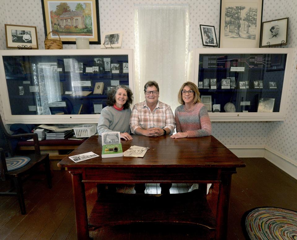 Board of Directors for the Edgar Lee Masters Memorial Museum, left to right, Treasurer Terri Treacy, President Kathy Olesen, and Secretary Jane Stephenson, sit at Edgar Lee Masters' desk Monday, March 18, 2024.