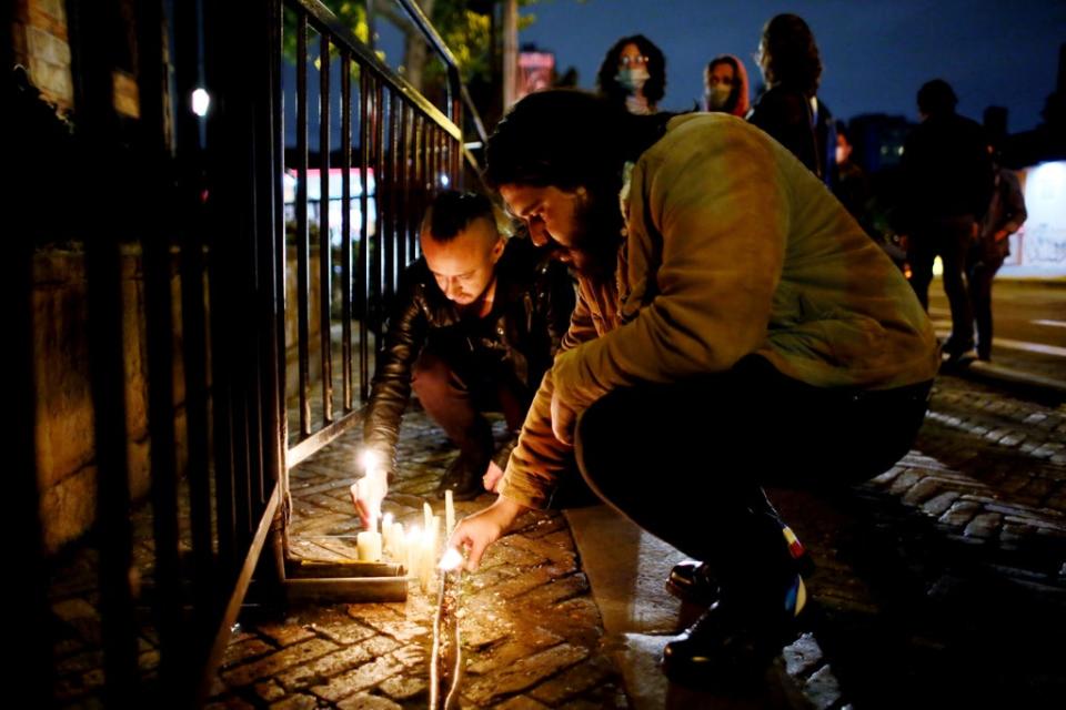 Fans of US band Foo Fighters place lights in front of the hotel where the band’s drummer Taylor Hawkins was found dead in Bogota, Colombia (Leonardo Munoz/AP) (AP)