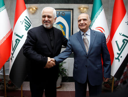 Iranian Foreign Minister, Mohammad Javad Zarif, shakes hands with Iraqi Foreign Minister Mohamed Ali Alhakim in Baghdad, Iraq May 26, 2019. REUTERS/Khalid Al-Mousily