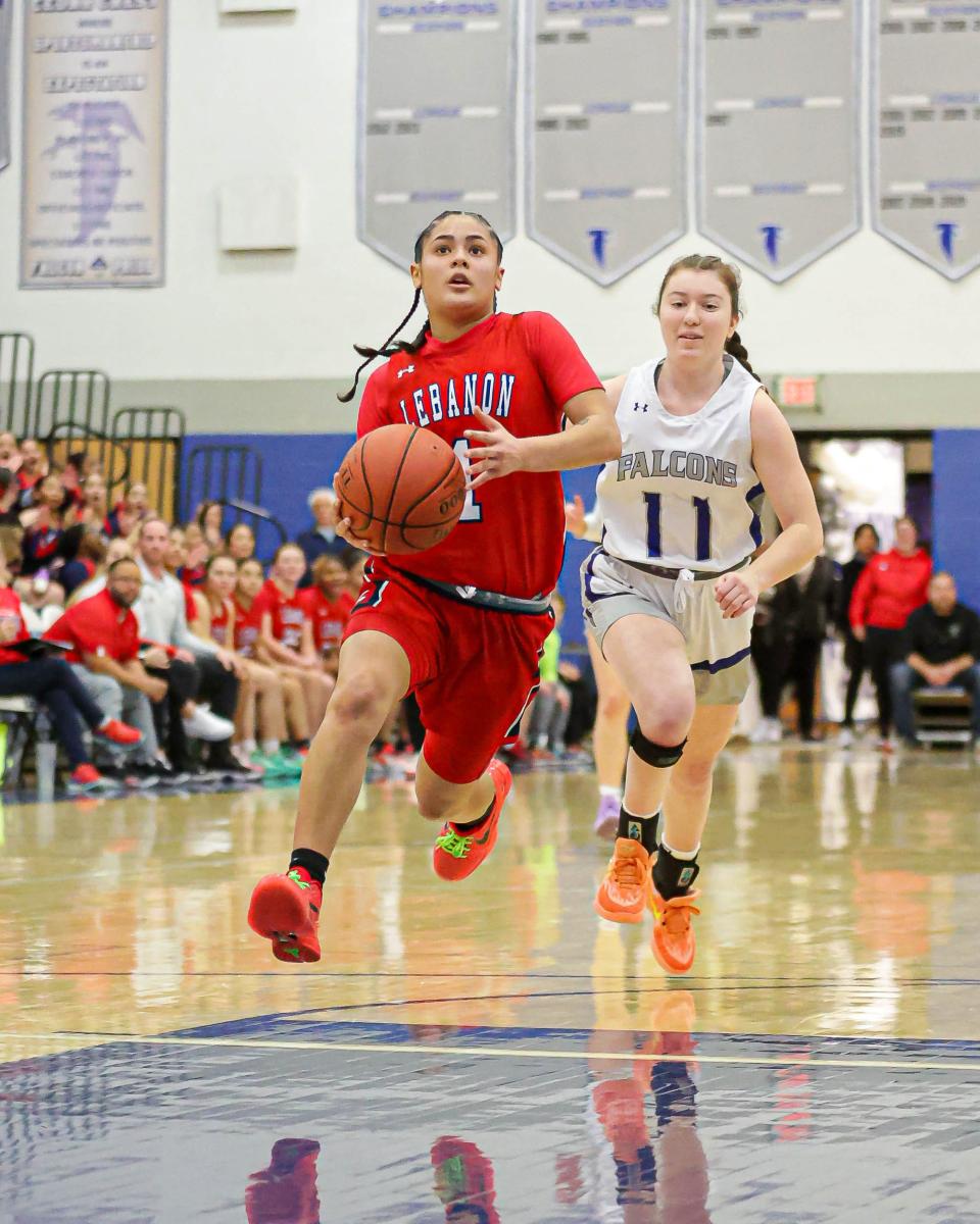 Kailah Correa (1) floats through the air past a trailing Sierra Margut (11) on her way to the bucket. The Lebanon Cedars took a short drive to south Lebanon to face the Cedar Crest Falcons in a LL League girls' basketball game on Friday, Jan. 5, 2024. The Cedars got past the Falcons 53-41.