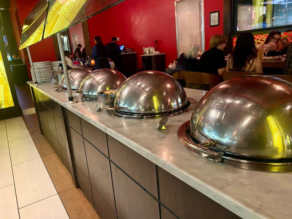 hot foods under metal domes on a buffet at texas de brazil steak house