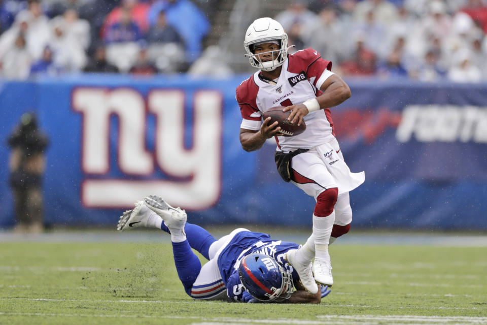 Arizona Cardinals quarterback Kyler Murray, top, evades a tackle by New York Giants' Oshane Ximines, bottom, during the first half of an NFL football game, Sunday, Oct. 20, 2019, in East Rutherford, N.J. (AP Photo/Adam Hunger)