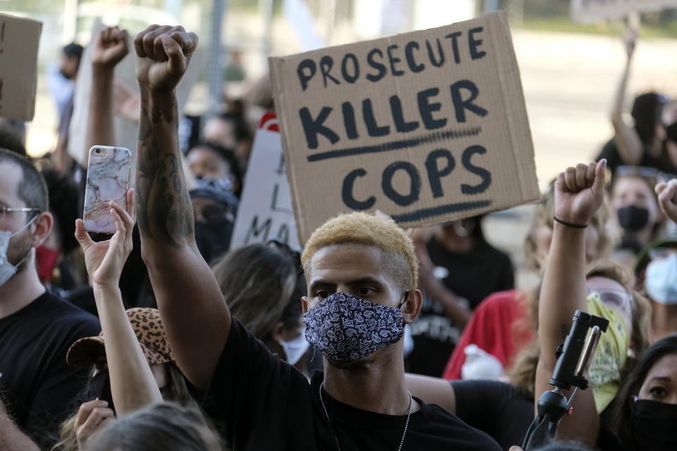 A demonstrator raises his fist during a protest of the death of George Floyd, a black man who was in police custody in Minneapolis, in downtown Los Angeles, Wednesday, May 27, 2020. (AP Photo/Ringo H.W. Chiu)
