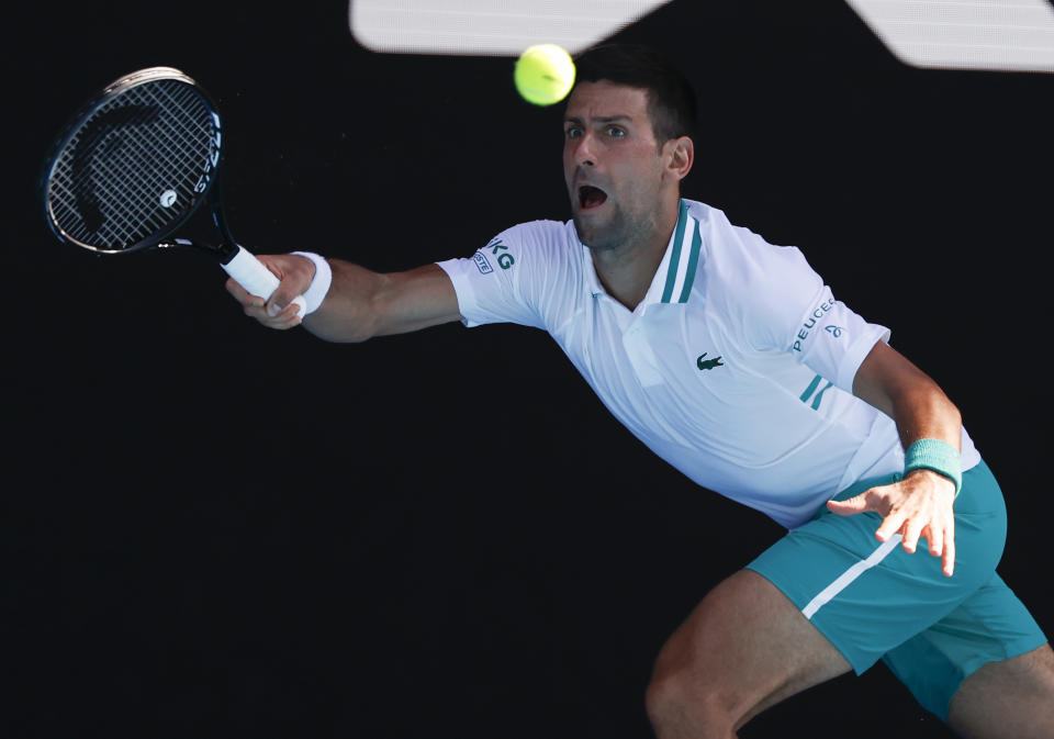 Serbia's Novak Djokovic makes a forehand return to United States' Frances Tiafoe during their second round match at the Australian Open tennis championship in Melbourne, Australia, Wednesday, Feb. 10, 2021.(AP Photo/Rick Rycroft)