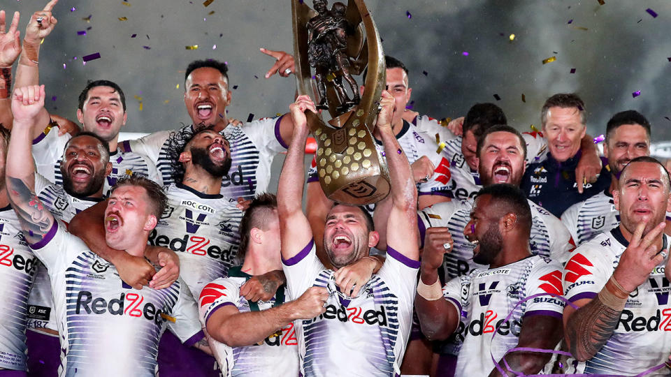 Pictured here, 2020 NRL premiers the Melbourne Storm celebrate with the trophy.