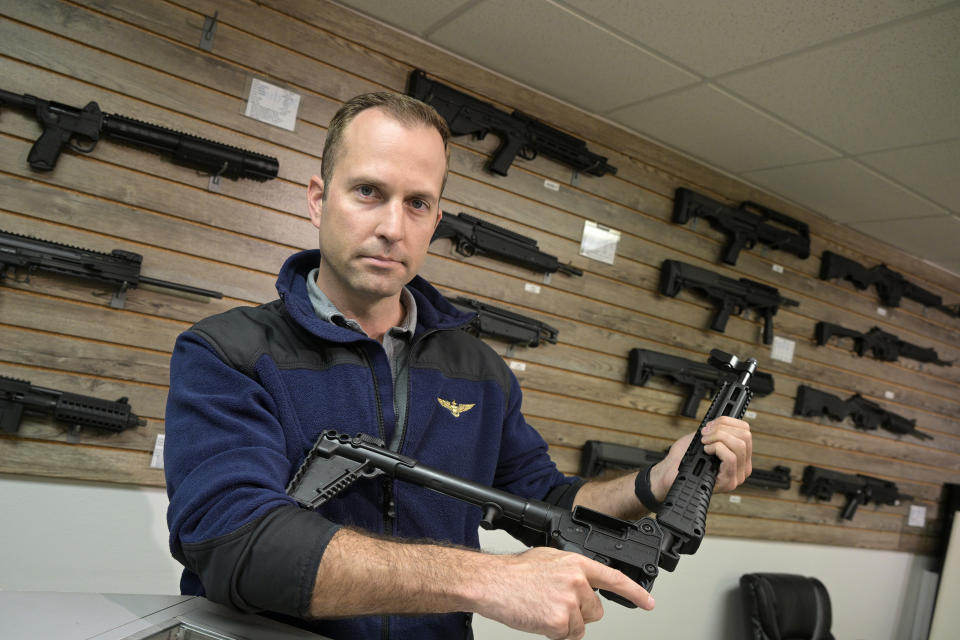 Adrian Kellgren, director of industrial production of KelTec, holds a 9mm SUB2000 rifle, similar to ones being shipped to Ukraine, at their manufacturing facility on Thursday, March 17, 2022, in Cocoa, Fla. Kellgren’s family-owned gun company was left holding a $200,000 shipment of semi-automatic rifles after a longtime customer in Odessa suddenly went silent during Vladimir Putin’s invasion of Ukraine. Fearing the worst, the company decided to put those stranded 400 guns to good use, sending them to Ukraine's nascent resistance movement. (AP Photo/Phelan M. Ebenhack)