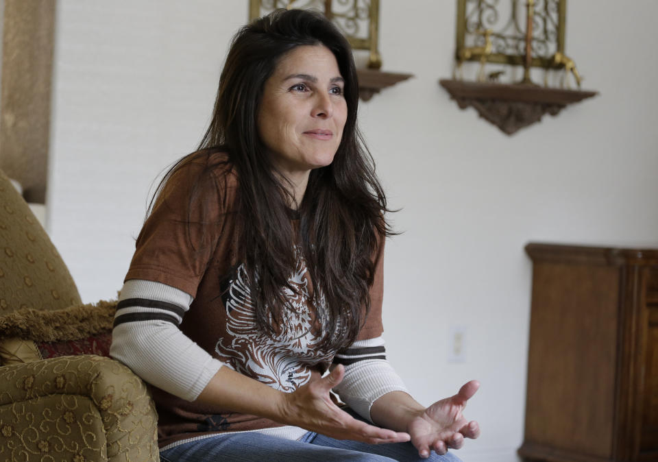 Judith Negron is interviewed at her home in Hialeah, Fla., Wednesday, Feb. 19, 2020. Negron was serving 35 years at a Florida prison for health care fraud, conspiracy and money laundering when she was released Tuesday after President Donald Trump commuted her sentence. (AP Photo/Terry Renna)