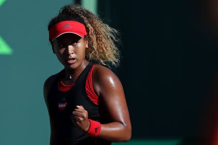 Mar 21, 2018; Key Biscayne, FL, USA; Naomi Osaka of Japan celebrates after winning the first set against Serena Williams of the United States (not pictured) on day two of the Miami Open at Tennis Center at Crandon Park. Osaka won 6-3, 6-2. Mandatory Credit: Geoff Burke-USA TODAY Sports