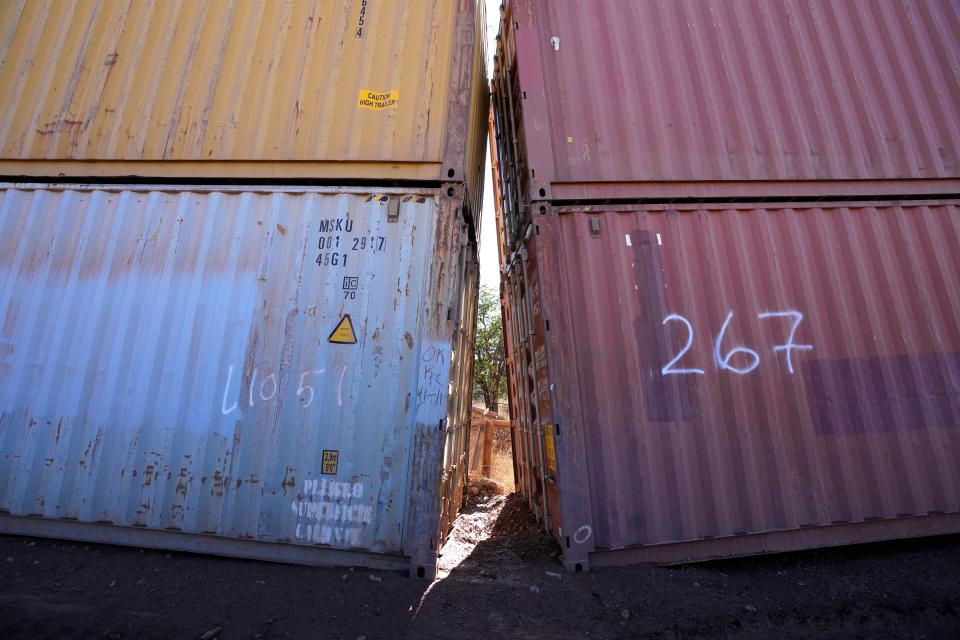 An awkward gap is shown between shipping containers at the bottom of a wash along the border where shipping containers create a wall between the United States and Mexico in San Rafael Valley, Ariz., Thursday, Dec. 8, 2022.