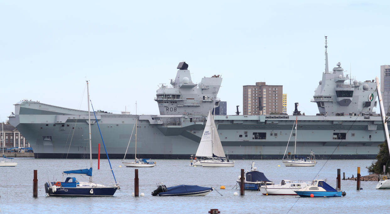 The Royal Navy aircraft carrier HMS Queen Elizabeth moored up at HMNB Portsmouth after its departure from the naval base for training exercises at sea was postponed for the second day in a row after a number of crew members tested positive for Covid-19.