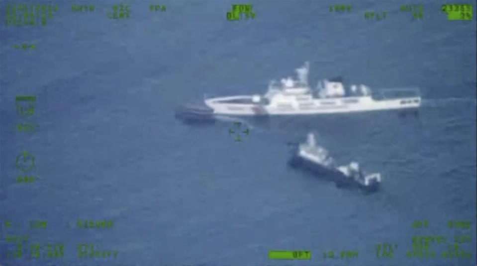 In this image released by the Armed Forces of the Philippines, a Philippines supply boat, top left, sails near a Chinese coast guard ship, top right, and a Chinese militia vessel off Second Thomas Shoal, locally called Ayungin Shoal, at the disputed South China Sea on Sunday Oct. 22, 2023. (Armed Forces of the Philippines via AP)