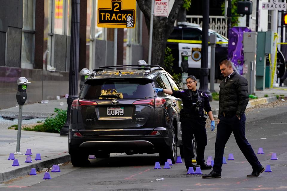 Investigators search for evidence in the area of a mass shooting In Sacramento, Calif. April 3, 2022. 