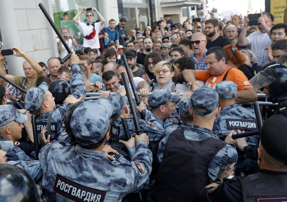 FILE - In this July 27, 2019, file photo, protesters clash with police during an unsanctioned rally in Moscow. The protest was the latest in a series of demonstrations denouncing the exclusion of some opposition and independent candidates from a Sept. 8 election for the Moscow city council. (AP Photo/ Pavel Golovkin, File)