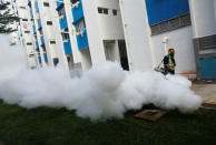 A worker fogs the drains in the common areas of a public housing estate at an area where locally transmitted Zika cases were discovered in Singapore August 31, 2016. REUTERS/Edgar Su