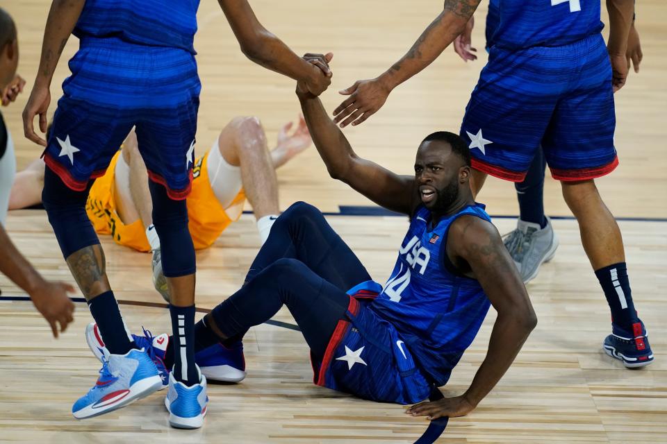 United States' Draymond Green is helped off the ground during an exhibition basketball game against Australia on July 12, 2021, in Las Vegas.