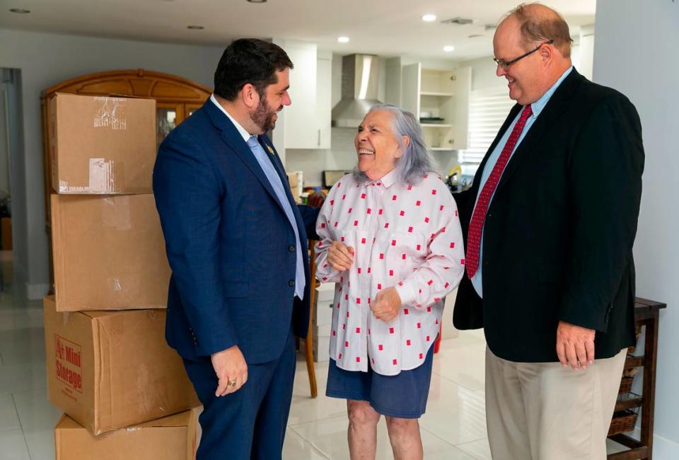 Ana Lazara Rodriguez is photographed alongside her attorneys, Bruce Jacobs, left, and David Winker, inside her new home in Miami’s Coral Terrace neighborhood on Monday, Sept. 27, 2021. Rodriguez, who was previously facing eviction, was able to move into this house after an anonymous benefactor bought her the four-bedroom, two-bath home for $690,000.