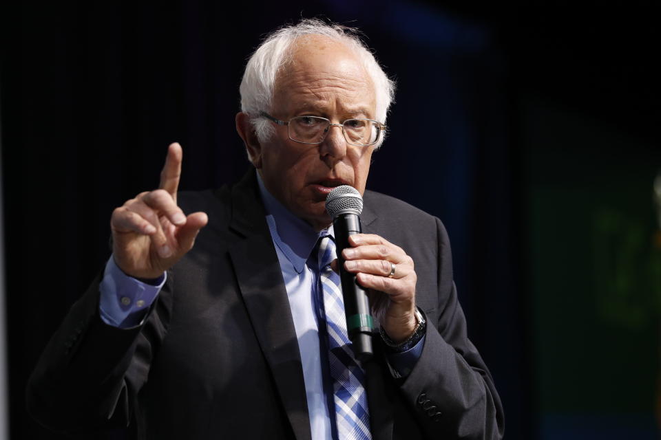 Democratic presidential candidate Sen. Bernie Sanders, I-Vt., speaks at the J Street National Conference, with the hosts of "Pod Save the World," Tommy Vietor, left, and Ben Rhodes, Monday, Oct. 28, 2019, in Washington. (AP Photo/Jacquelyn Martin)